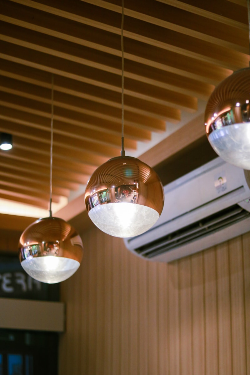 Photo by ikhbale A group of lights hanging from a ceiling